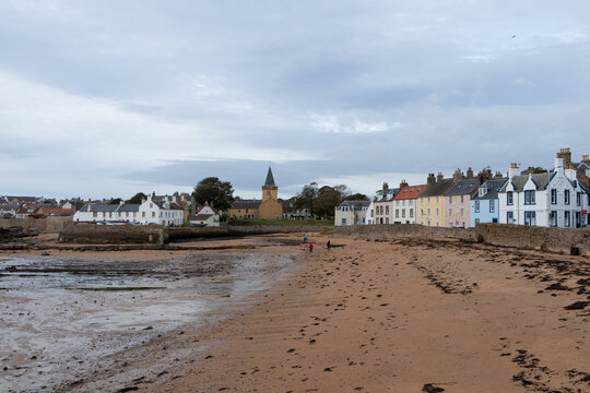 Historic Anstruther Easter Parish Church and traditional coastal houses viewed from the sandy beach in Anstruther, Fife, Scotland