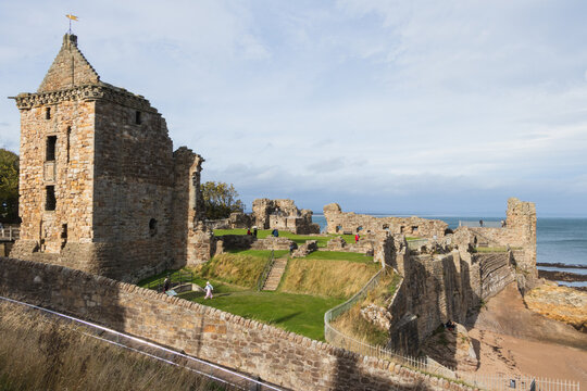 Historic medieval ruins of St Andrews Castle and ancient stone towers standing on the scenic rocky coastline in Fife, Scotland