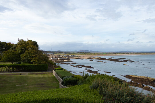 Scenic coastal view of St Andrews coastline, sandy beach, and rocky shore in Fife, Scotland