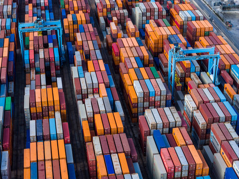 Vado Ligure, Liguria, Italy - 18 September 2026: Aerial view of the container terminal in Vado Ligure, featuring rows of colorful shipping containers and large gantry cranes.