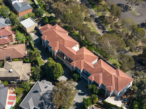 Melbourne, Victoria, Australia - 08 October 2026: Aerial view of residential houses with terracotta tiled roofs and surrounding trees in a suburban neighborhood.