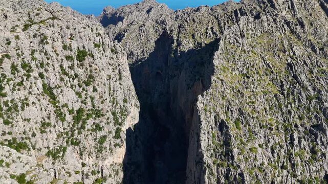 Spherical panorama of a rocky valley and gorge near Mirador de s'Entreforc, Escorca, in Mallorca's Serra de Tramuntana, Balearic Islands, Spain, beneath the sun.