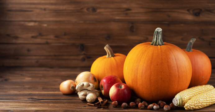 Flat lay arrangement with pumpkins on wooden background