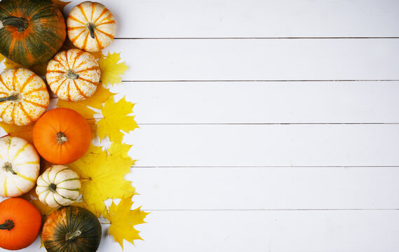 Flat lay arrangement with pumpkins on wooden background