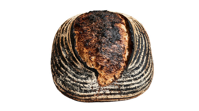 Isolated rustic sourdough bread loaf with darkly baked, patterned crust, delicious traditional food