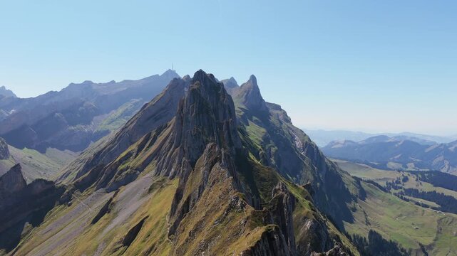 Appenzell, Switzerland. Aerial view of rocky mountain peaks and wild nature landscape. High altitude mountain ridge under open sky. 