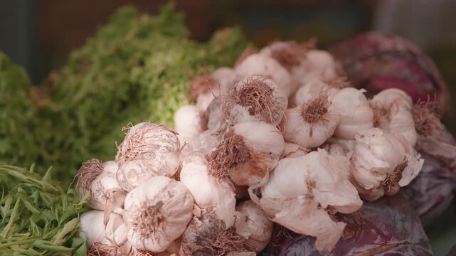 Close Up of Fresh Garlic Bulbs Displayed on Grocery Market Stall