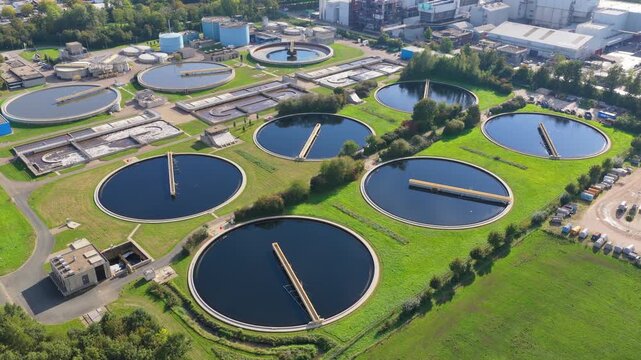 Aerial drone view of a water treatment plant facilities. Circular sedimentation tanks and filtration basins at a modern sewage facility.