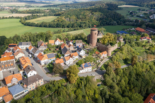 Trendelburg, Hessen, Germany - 18 September 2026: Aerial view of Trendelburg Castle surrounded by traditional half-timbered houses and lush green forests.