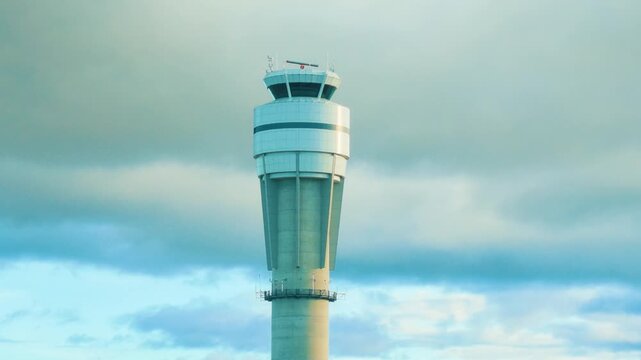 Calgary, Alberta, Canada - October 14, 2026: Tall freestanding NAV CANADA air traffic control tower facility at Calgary International Airport under a cloudy sky