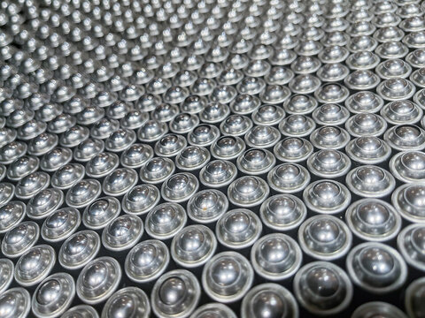 High angle full frame background of non return oil pump check valves arranged in rows inside a factory tray during assembly and quality control process in automotive manufacturing plant