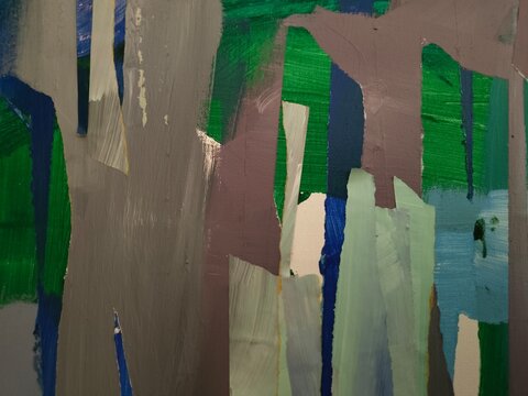 Torn and painted shapes in grey, mauve, pale mint and light blue overlap a rich green ground with narrow deep-blue lines. The surface shows soft brushstrokes and torn paper edges.