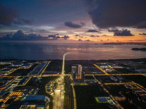 Simpang Ampat, Penang, Malaysia - 05 October 2026: Aerial view of Batu Kawan and the Sultan Abdul Halim Muadzam Shah Bridge at sunset, showing industrial zones, buildings, and the bridge.