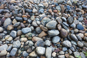 Pile of Smooth River Rocks and Pebbles in Natural Outdoor Setting. © Jajar