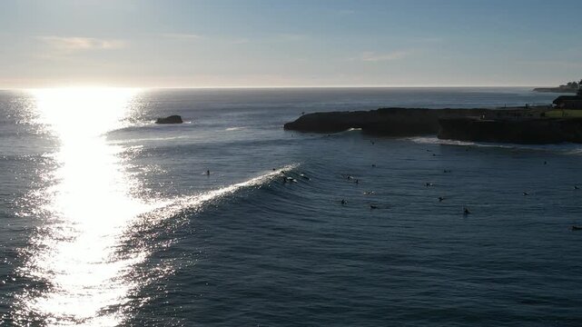 Aerial lighthouse and cliff line with rows of whitewater, backlit ocean, Santa Cruz
