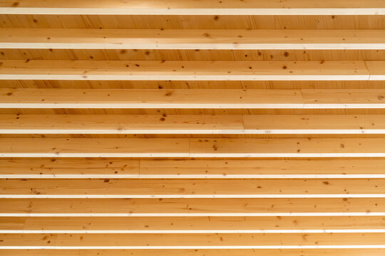 Natural wood ceiling structure showing parallel timber beams