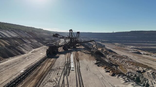 Aerial view of spreader 757 depositing overburden beside a belt conveyor on a mine bench at Hambach, North Rhine-Westphalia, Germany.