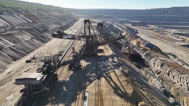 Close aerial view of overburden spreader 757, its crawler units, steel booms and conveyor system at Hambach lignite mine in North Rhine-Westphalia, Germany.