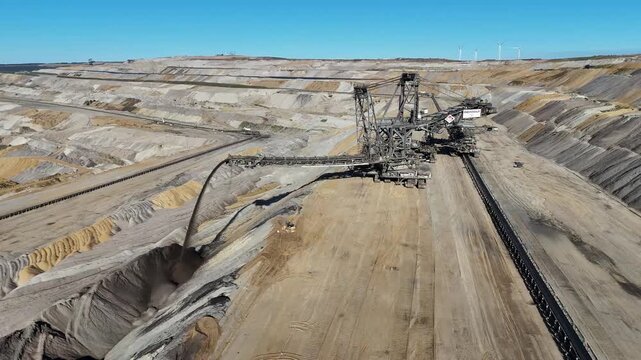 Close aerial view of overburden spreader 757, its crawler units, steel booms and conveyor system at Hambach lignite mine in North Rhine-Westphalia, Germany.