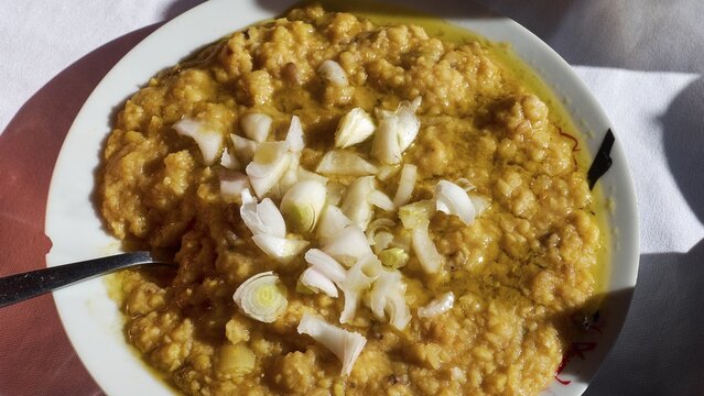 Fava, A plate of a traditional dish, chunky and garnished with onions, served on white crockery, Drakona, Slowfood, Restaurant Dounias, Lefka Ori, White Mountains, Massif, West, Crete, Greece