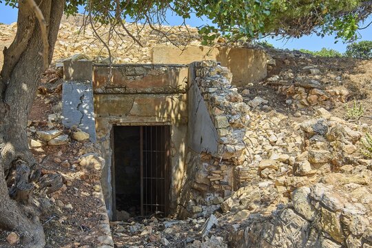 Closed ruin made of stone next to a tree in a sunny landscape, Lost Place, Air Defence Position, Aerophone, Parabolic Acoustic Mirror, Patella Mountain, WW2, west of Lakki, Leros, Dodecanese, Greek Islands, Greece