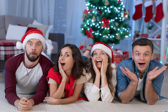 Four Friends Making Surprised Faces at Christmas Party
