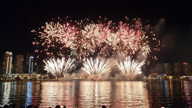 Fireworks Display Over Water at Night City Skyline New Year Celebration Festival