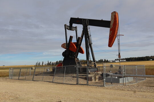 A pumpjack, pumping crude oil into a pipeline or holding tank on the well site. Also known as a nodding donkey, horsehead, or oil horse and beam pump. 
