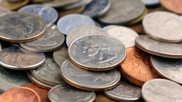 Many various coins of different countries circle rotation close up
