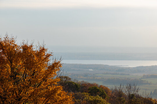 Bright evening sun shining over autumn forest valley landscape. Champlain Lookout in Gatineau Park, Canada.