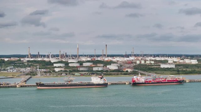 Gas tankers over refinery Esso Oil Terminal from drone, Southampton, Hampshire, England, United Kingdom