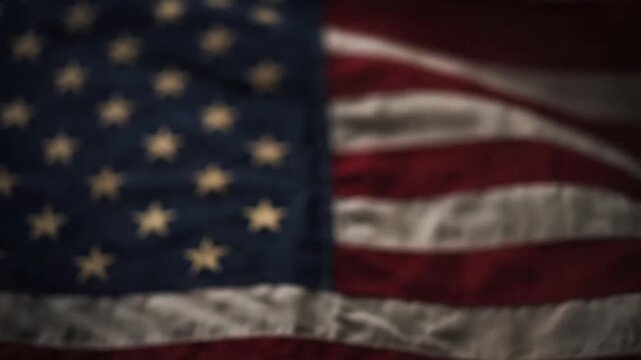 National flag with stars and stripes waving softly in dim lighting