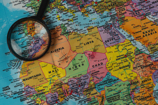 Exploring a world map with a magnifying glass to find locations