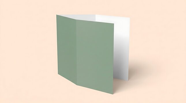 A blank folded green brochure mockup standing upright on a soft pastel peach colored surface background. bi fold mockup