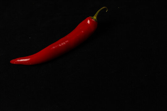 Red chili pepper on a black background for cooking
