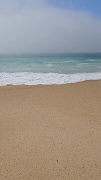 Praia do Norte or North Beach in Nazar&eacute; Portugal with ocean waves vertical video
