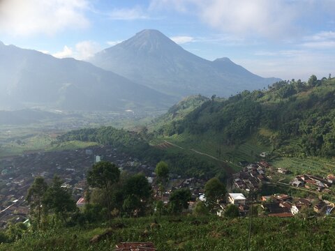 Mountain Valley Village View on Train with Agricultural Terraces and Peak in Central Java