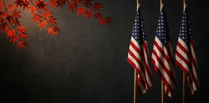 American Veterans Day Three American flags standing against dark textured wall with red autumn maple leaves