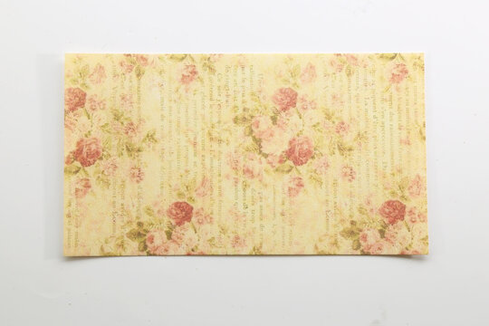 Soft pastel vintage floral paper with delicate pink flowers for romantic stationery and scrapbook designs.