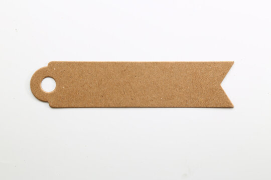 Blank brown kraft banner tag with a punched hole for product labels, gifts and rustic packaging.