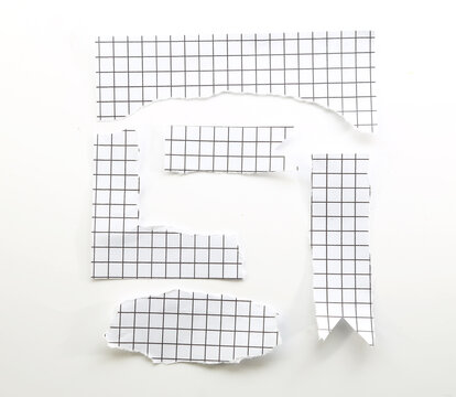 Torn white grid paper pieces arranged as abstract cutouts for collage, scrapbooking and creative design.