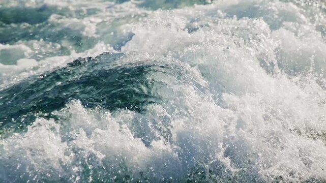 Ocean waves crash with white foam and blue-green water. in this dynamic sea scene. Perfect for travel, adventure, or nature-themed projects. Useful for websites, ads, or video backgrounds