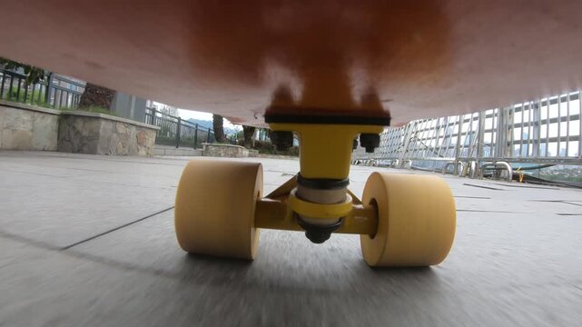 Skateboarder riding skateboard on street in chongqing city ,China.Under skateboard  POV