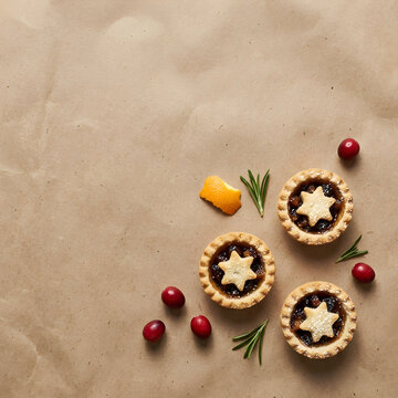 Traditional Christmas mince pies on rustic brown paper, festive holiday fruit tarts with star pastry, seasonal winter dessert with cranberries