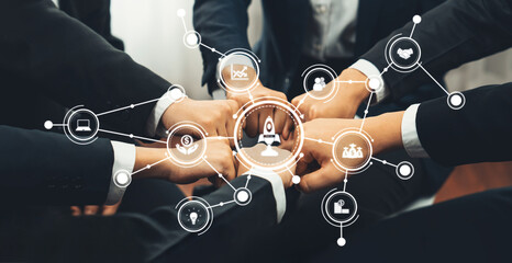 A group of professionals showing teamwork through connected hands, surrounded by business icons...
