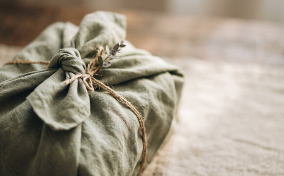 Eco friendly gift wrapping with green cloth and twine in a sustainable zero waste lifestyle concept