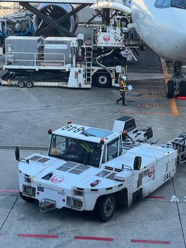 Tokyo, Japan - Nov.01.2023: Airport Pushback Tractor and Ground Handling Operations on the Tarmac