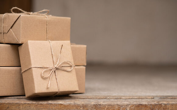 Wrapped gift boxes stacked on wooden table for holidays and birthdays concept