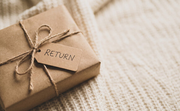 Wrapped return package with a tag on a knitted background representing online shopping logistics and e-commerce product returns