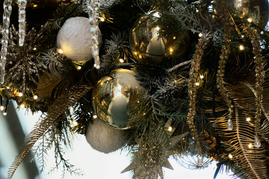 Gold Christmas Baubles Reflect Twinkling Lights on the Tree